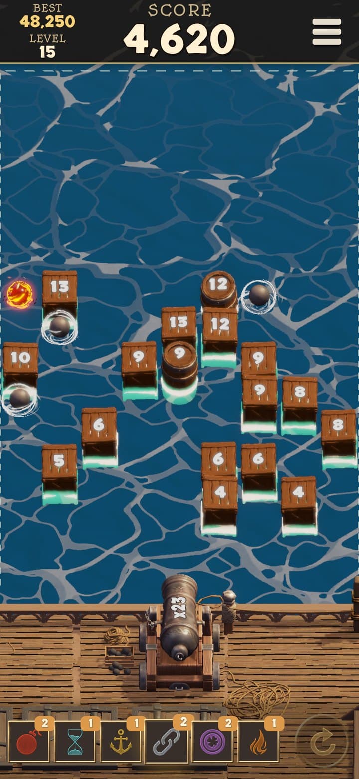 The power-up bar along the bottom with six kinds of power-up ready, and crates drifting toward the cannon