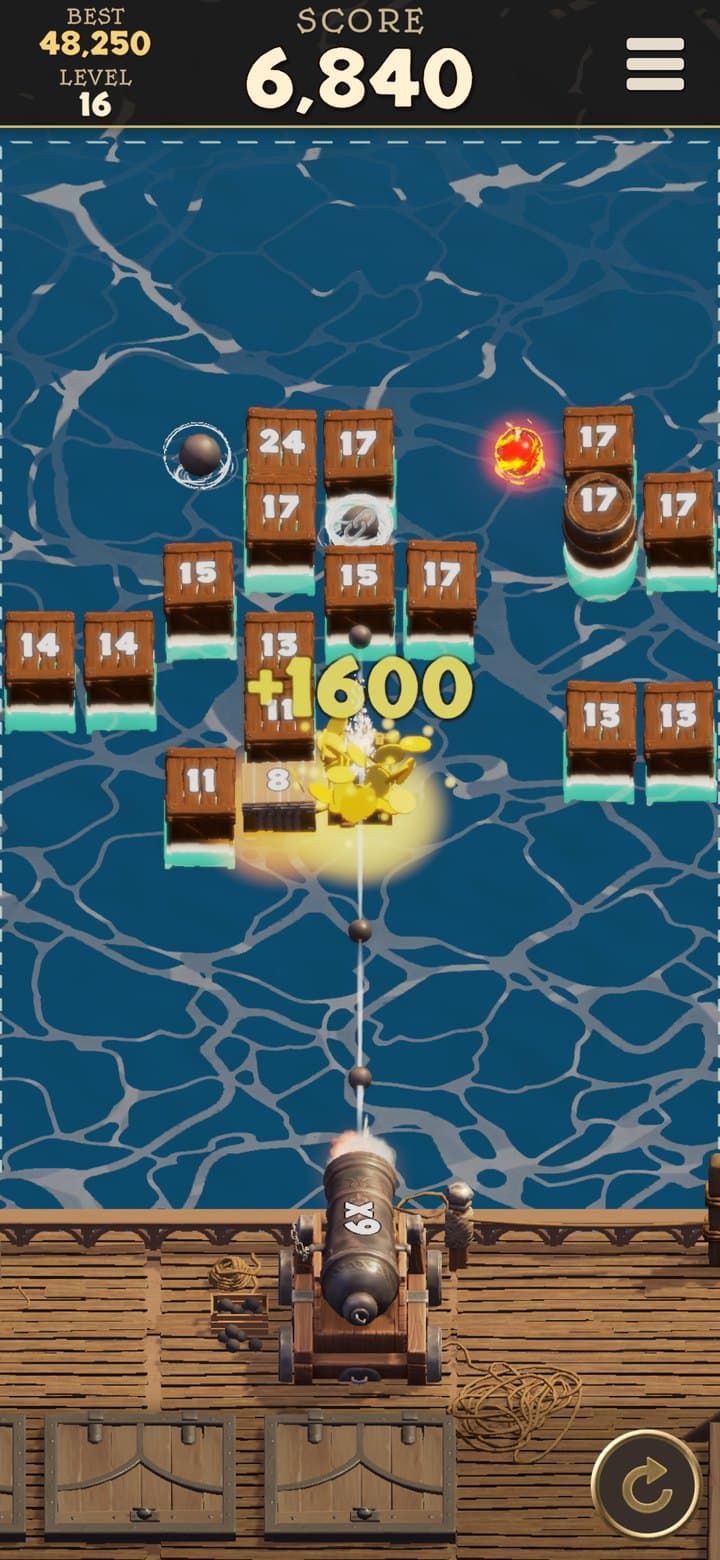 A gold treasure chest bursting into a shower of coins worth 1,600 points among the crates